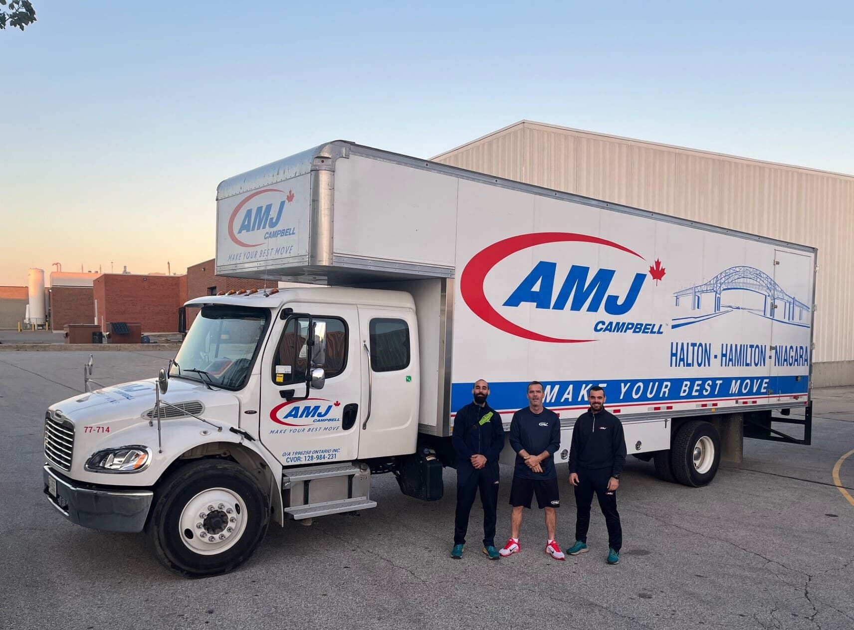 AMJ Halton/Hamilton/Niagara truck with 3 movers standing in front.